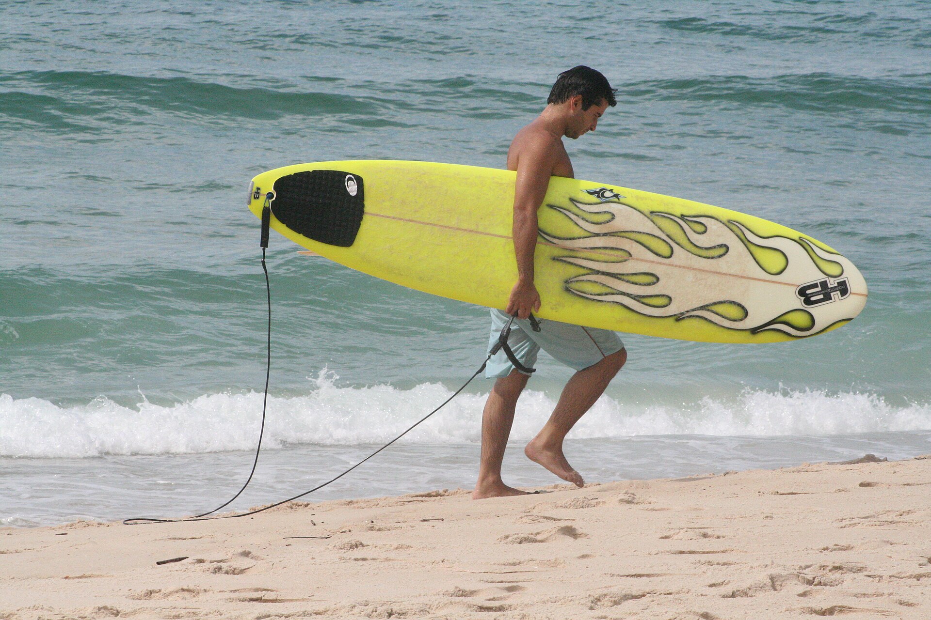 surfer carrying surfboard